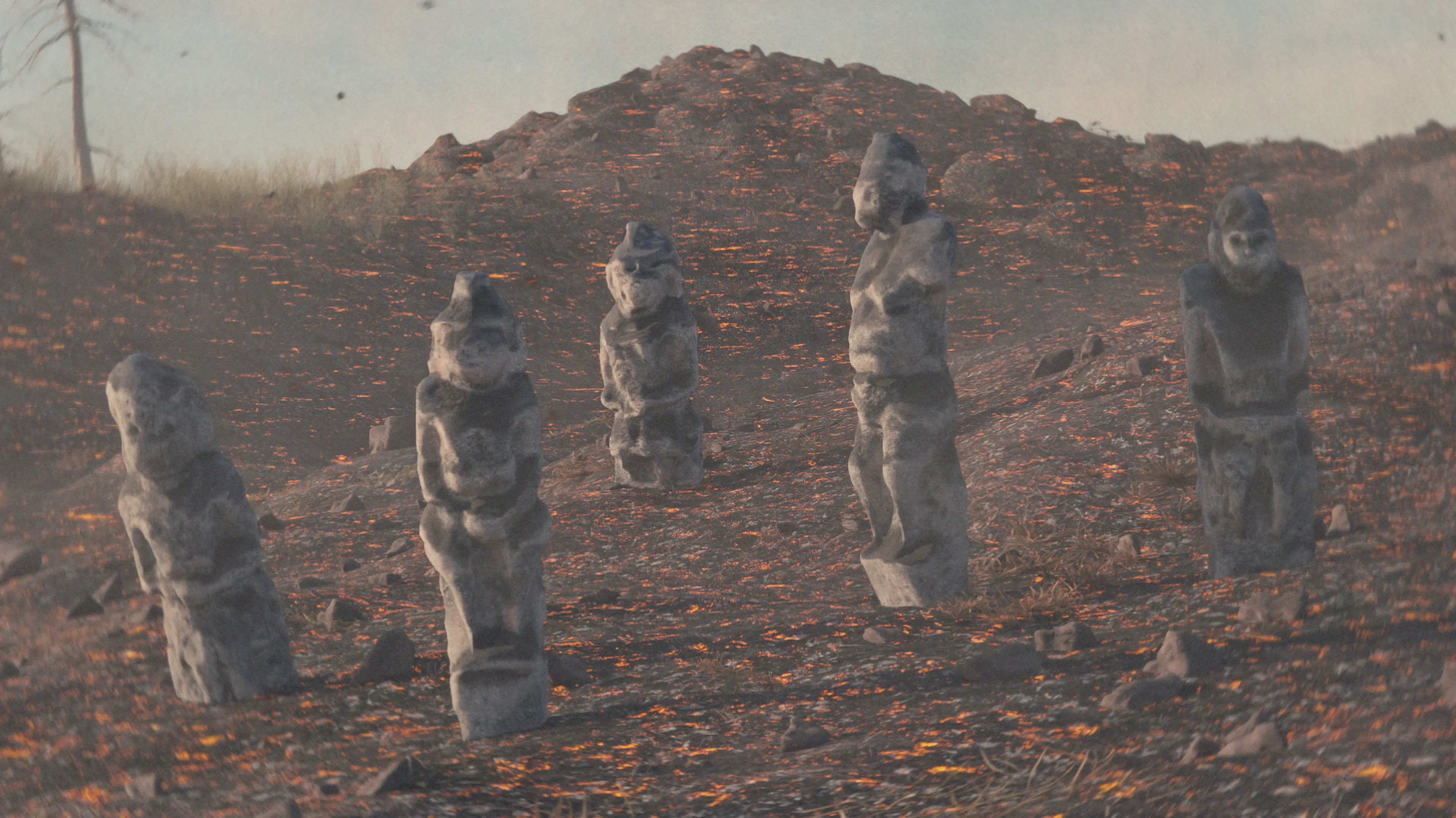 Cinematic visualization of mysterious stone statues dotting a vast and barren rocky landscape under an overcast sky, conveying a sense of history.