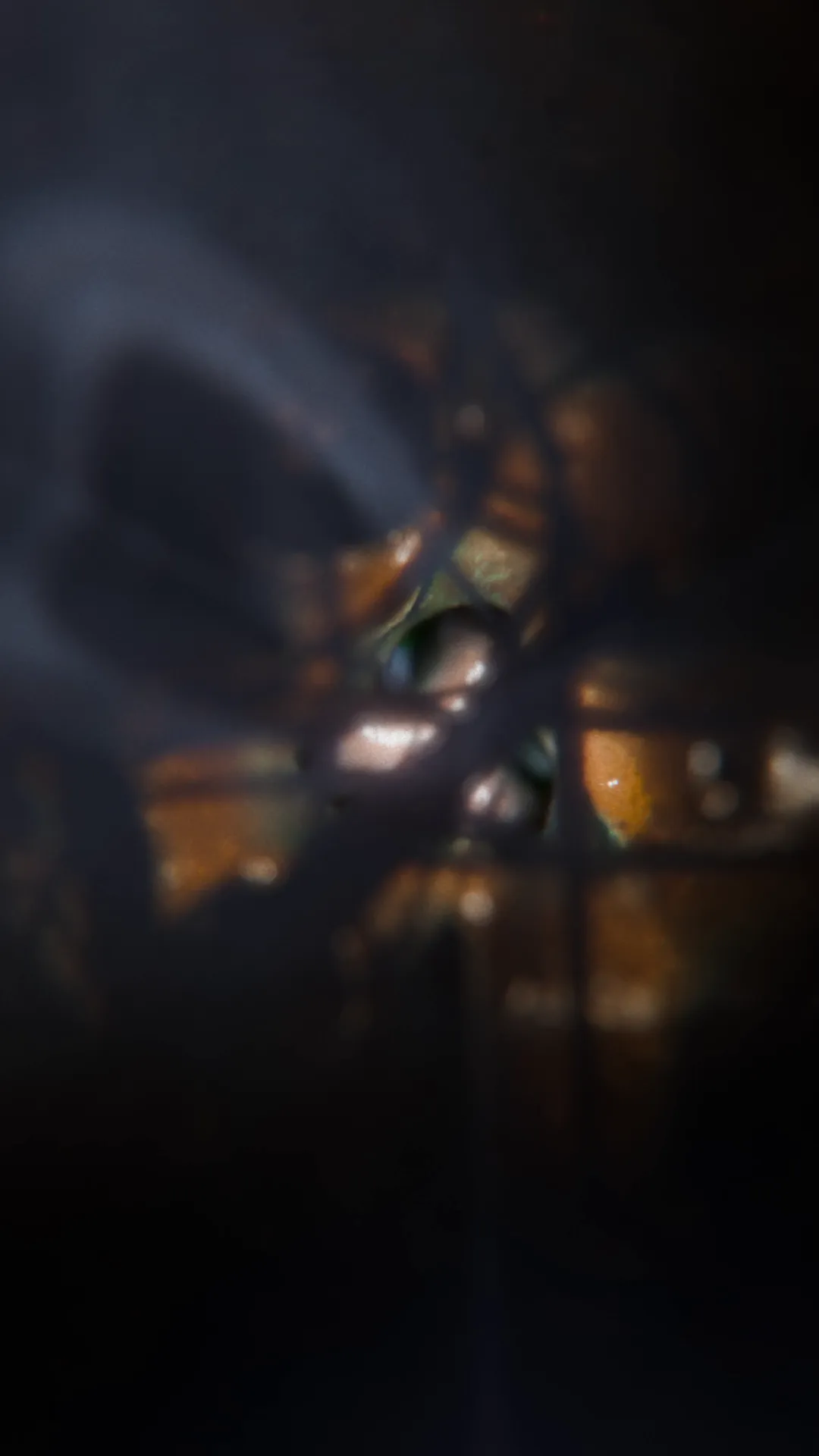 Atmospheric digital render looking through a surreal, cavernous form with distant orange light, creating a mysterious and abstract environment.